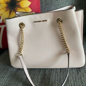 Large Michael purse the color is a light pink cream color